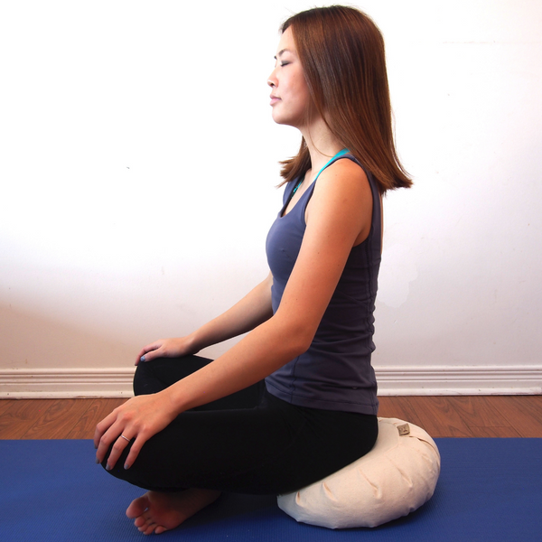 Meditating on zafu meditation cushion