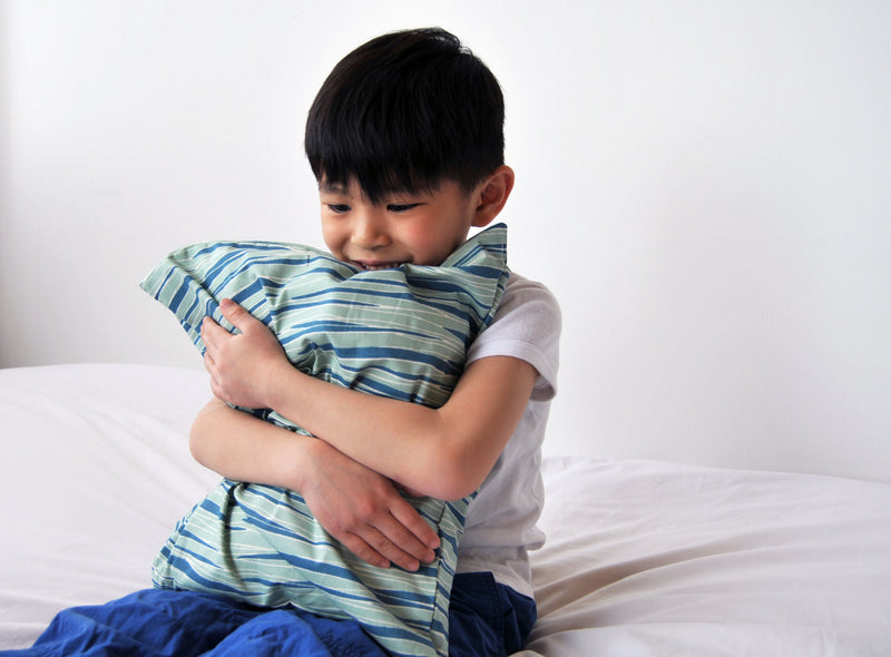 Boy hugging Toddler pillow